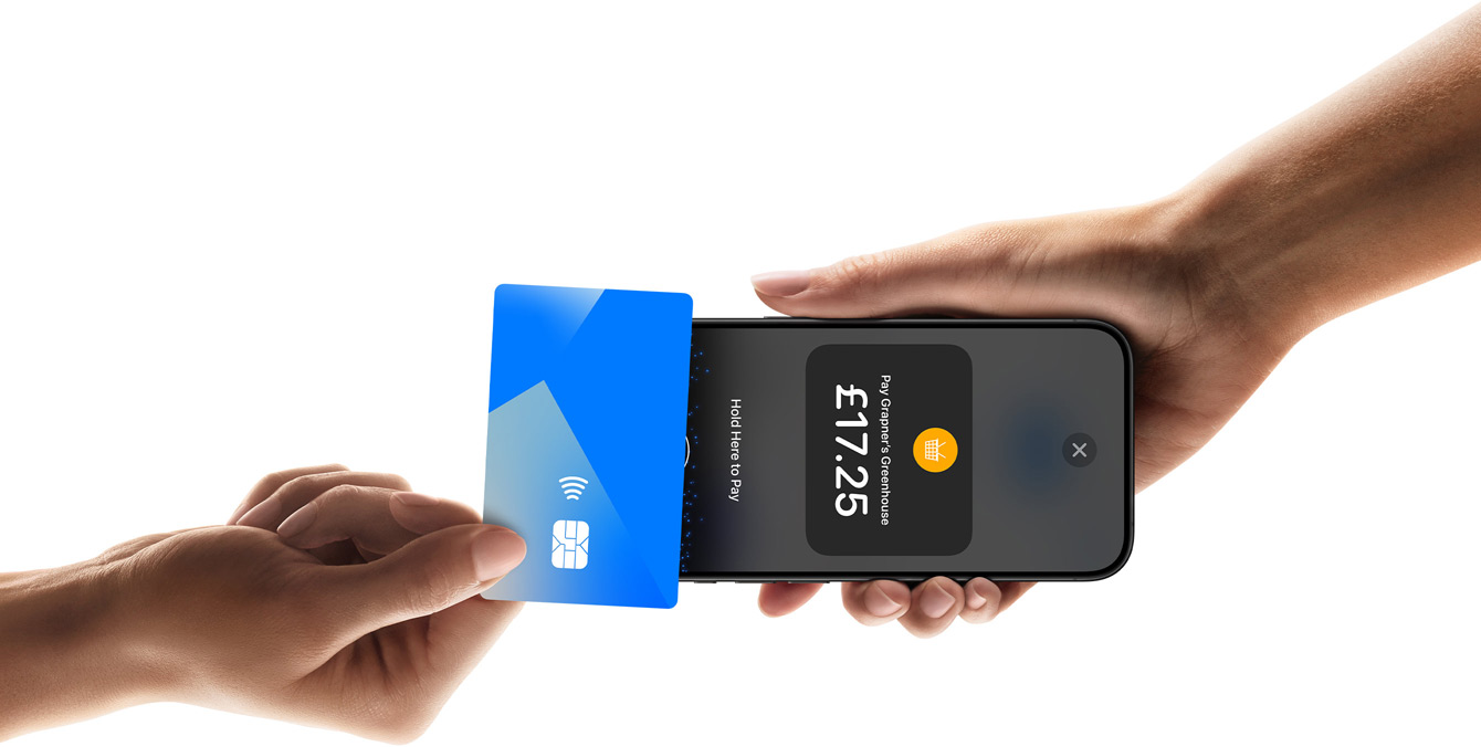 An image of a hand tapping a credit card on an iPhone device that another person is holding, with the iPhone screen showing transaction information.