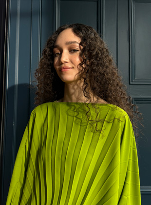 A photo shot in 35 mm of a woman in a green dress