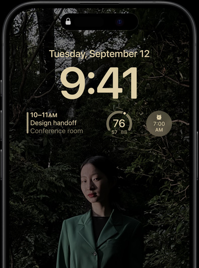 The Always-On display of iPhone 15 Pro showcasing a Lock Screen with a calendar widget, a weather widget, and an alarm widget