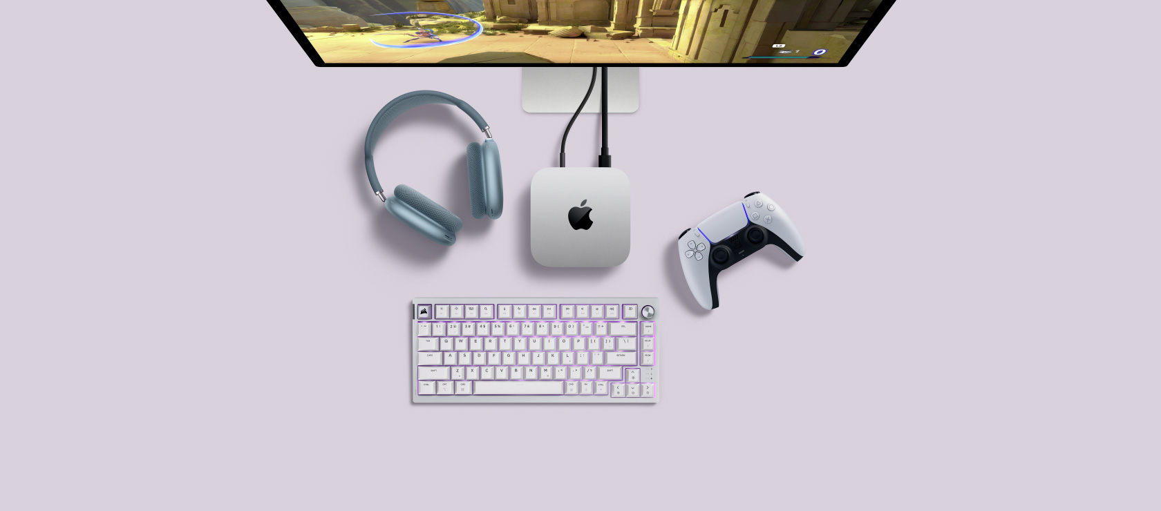 A desk setup showing Mac mini plugged into a display and next to a wireless keyboard and mouse.