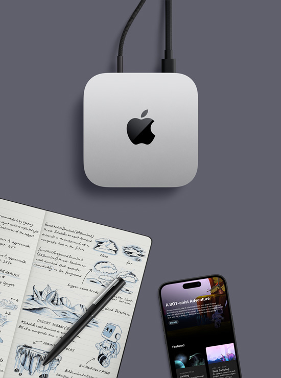 Top-down view of silver Mac mini with Apple logo, in a desk setup next to an iPhone, a pen, and an open notebook showing handwritten notes